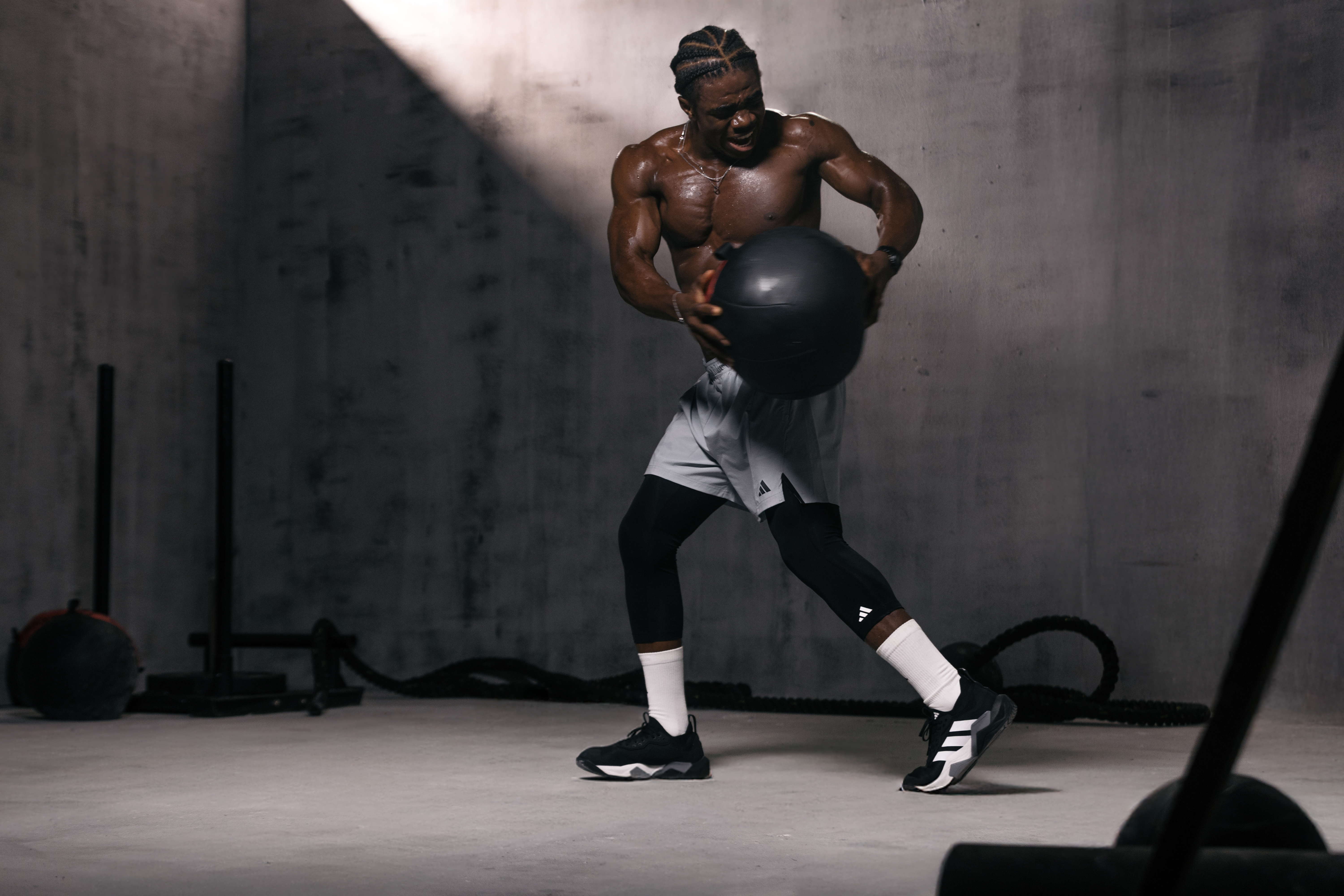 VV Fitness trainer driving a medicine ball through a power drill